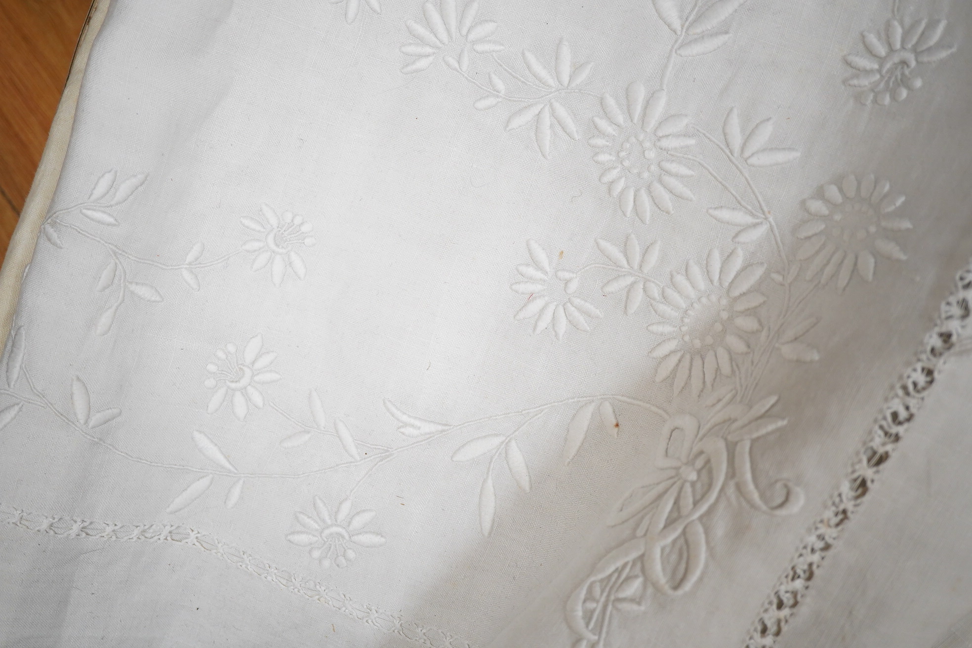 Four 19th century French provincial linen top sheets. Two with deep heavily floral embroidered turn backs, another with tear drops embroidered on the turn back, the other a narrower sheet with a single embroidered monogr